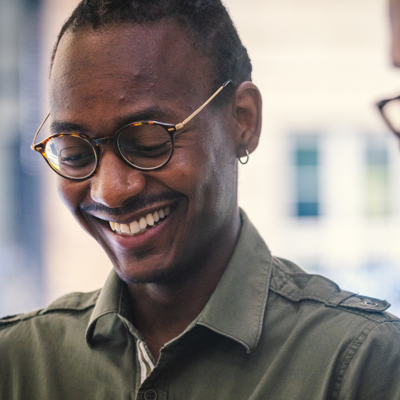 Man with glasses laughing