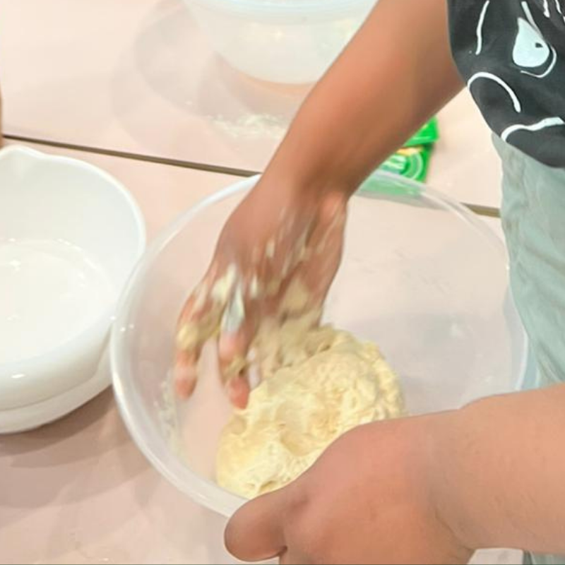 Hands kneading dough together