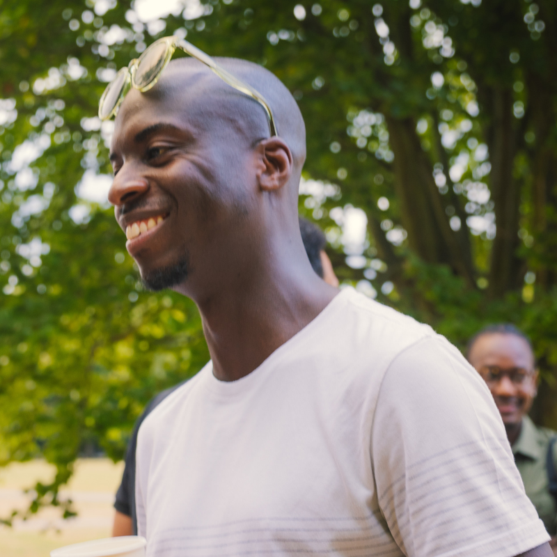 Man smiling in the sun at the gathering