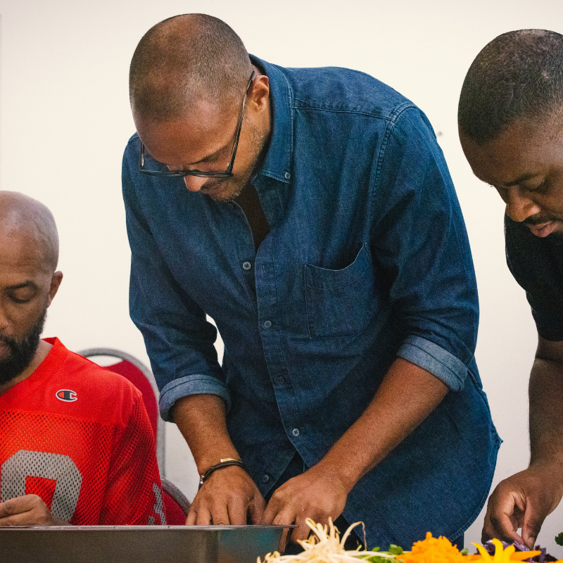 Three men cooking together