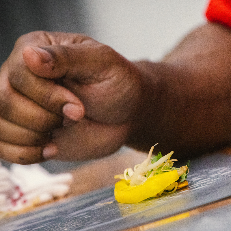 Hands resting beside food — care and presence